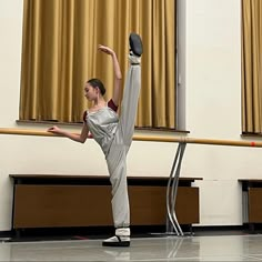 a young woman is practicing her moves on the dance floor