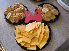 a mickey mouse plate with cheese and crackers on it