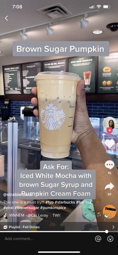 someone is holding up a starbucks drink in front of the camera and looking at it