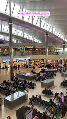 an airport filled with lots of people sitting and standing