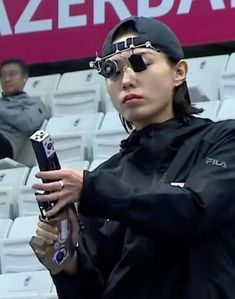 a woman wearing blindfolds and holding a baseball bat