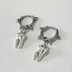 These goth-inspired hoop earrings, featuring a unique tooth and spiked design, are perfect for those who love to make a bold statement. They offer a cool, unique style that's sure to turn heads. Goth aesthetic Metal Package: 1 pair of earrings Earrings Grunge, Hip Hop Trends, Spike Hoop Earrings, Y2k Jewelry, Alloy Earrings, Estilo Punk, Trendy Earrings, Cross Earrings, Creative Jewelry