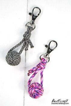 two key chains that are tied to each other and one has a knot on it