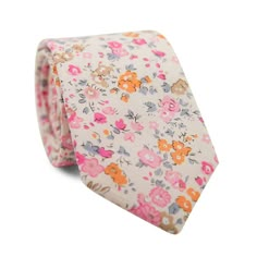 a white tie with pink, orange and blue flowers on it's end is against a white background