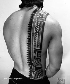 the back of a man's upper half with an intricate tattoo design on it