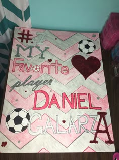 this is a sign that says, my favorite player daniel galaa with soccer balls on it