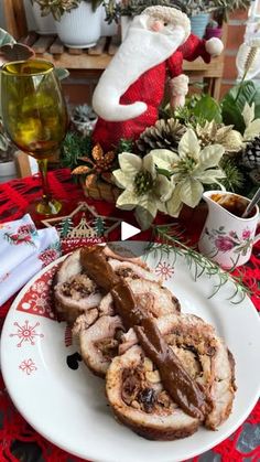 a plate full of food sitting on a table next to a christmas tree and other holiday decorations