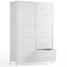 a tall white cabinet with drawers next to it