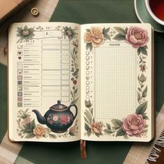 an open notebook with a teapot and flowers on it