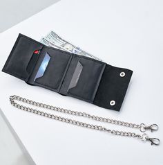 This personalized wallet with chain is a stylish and functional accessory that is perfect for anyone who wants to keep their valuables safe and secure while on the go. Handmade with care, this wallet is crafted from high-quality leather, which not only looks great but is also durable and long-lasting. The wallet features a spacious interior with multiple compartments for storing your cash, cards, and ID. It also comes with a chain that can be attached to your belt loop, making it easy to keep your wallet close at hand while on the move. The wallet can be personalized with your name or initials, which adds a personal touch and makes it a unique accessory. The personalization is done using a laser engraving technique that produces a crisp and clean finish, ensuring that your name or initials Leather Wallet With Chain, Rectangular, Leather Chain Wallet Rectangular, Rectangular Leather Wallet With Chain, Black Wallet With Chain For Everyday Use, Black Chain Wallet For Everyday Use, Chain Wallet Biker, Wallet With Chain, Biker Chain, Handmade Chain