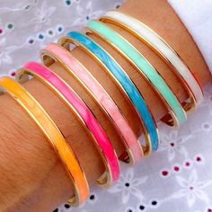 "Absolutely head over heels in love with our new Amalfi Enamel Cuffs. Available in 6 mouthwatering colours, they will look beautiful worn on their own or as part of a stack. Perfect for summer!  Size: 5mm wide. Fits small & medium wrist (size up to 17cm). We advise giving a gentle \"open\" to fit.  Good quality Gold Plated brass.  To make your jewellery last longer, we advise removing before exposing to water." Minimalist Bangle, Arm Bracelets Upper, Head Over Heels In Love, Hand Painted Beads, Arm Bracelets, Emerald Bracelet, Bridemaids Gifts, Gemstone Bangle, Gold Plated Bangles