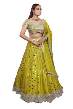 Lime green attached can-can lehenga featuring mirror hand work with mirror hand work lace hem. Paired with a zari, mirror hand embroidered scallop neck and waist padded blouse. Comes with a scallop hem, mirror embroidered dupatta. - Aza Fashions Green Choli With Mirror Work For Party, Party Green Choli With Mirror Work, Traditional Green Choli With Mirror Work, Dola Silk Choli With Sequins For Festivals, Pista Green Choli With Gota Work In Traditional Drape, Designer Green Sequined Lehenga, Green Lehenga With Mirror Work For Party, Green Chinon Lehenga For Navratri, Sequin Dola Silk Choli For Festivals