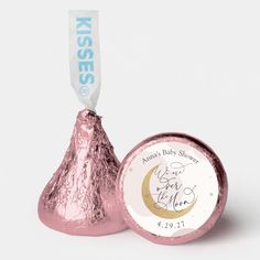 a pink foiled herss candy with a baby shower tag on it