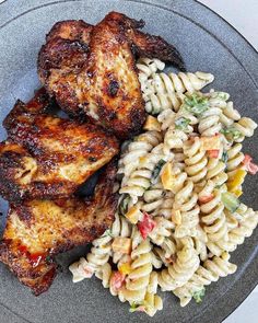 some chicken and pasta are on a plate