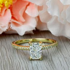 a yellow gold ring with a diamond set in the center