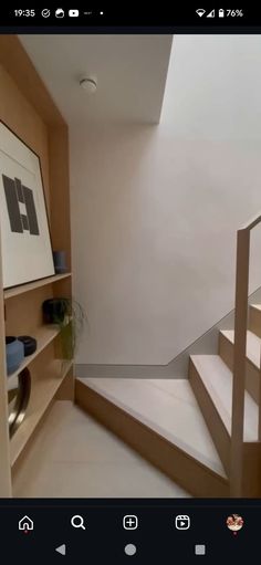 a room with some stairs and pictures on the wall next to it is shown in an instagram