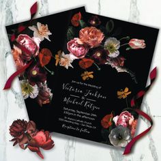 the wedding card is decorated with flowers and ribbon on marble background, it looks like an artistic floral arrangement