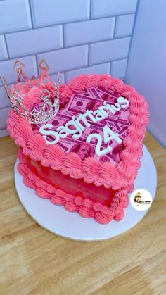 a heart shaped cake with the words sorry to you written on it and a crown