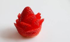 a close up of a strawberry on a white surface