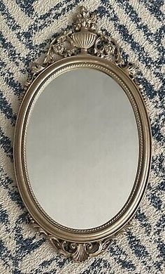 a mirror sitting on top of a carpet covered floor