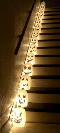 lighted pumpkins are lined up on the stairs