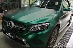 a green car is parked in a garage