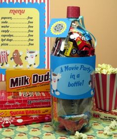 a bottle filled with candy next to boxes and popcorn