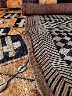 a close up of a bed with an intricate design on the coverlet and pillows