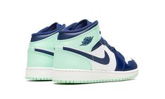 The Air Jordan 1 Mid GS “Blue Mint” is the youth sizing of the classic basketball shoe in a colorway that mixes refreshing blue and mint green hues.  The Jordan 1 Mid GS “Blue Mint” features a white leather base with Mystic Navy leather overlays on the toe cap, forefoot, and eyelets.  The same shade of blue is also found on the leather Swoosh and on the “Wings” logo on the collar.  Both the collar and heel panels are arranged in Mint Foam leather.  As is the nylon pull tab on the heel. Jordan 1 Mid Blue, Mint Shoes, Air Jordan 1 Mid Gs, Wings Logo, Kids Jordans, Air Jordan 1 Mid, Navy Leather, Jordan 1 Mid, Custom Shoes