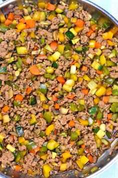 a pan filled with meat and vegetables on top of a table