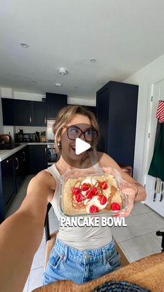 a woman is holding up a pancake bowl in her kitchen with the caption pancakes