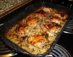 a casserole dish with chicken and rice in it on top of the stove