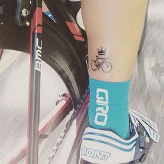 a person with a bike tattoo on their leg