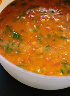 a white bowl filled with soup on top of a table