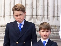 two young boys in suits and ties standing next to each other