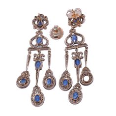 This is part of Chairish’s Fine Jewelry assortment.  Vintage 9.71 CTW sapphire & diamond girandole dangle earrings. These Victorian style vintage earrings are crafted in 18 karat yellow gold topped with silver. They feature 9.71 CTW of oval sapphires that are very well matched, eye clean, and have slight color zoning. These earrings are accented with 246 full cut diamonds at 2.00 carats total weight. The diamonds have VS1-2 clarity, with a few SI2, and have K-L-M light brown color. These earring Fine Jewelry Chandelier Earrings With 17 Jewels, Fine Jewelry Chandelier Drop Earrings, Ornate Hallmarked Chandelier Dangle Earrings, Ornate Hallmarked Dangle Chandelier Earrings, Formal Rose Cut Diamond Chandelier Earrings, Elegant Rose Cut Diamond Chandelier Dangle Earrings, Elegant Yellow Gold Chandelier Earrings With 17 Jewels, Formal Chandelier Earrings With Rose Cut Diamonds, Victorian Yellow Gold Dangle Jewelry