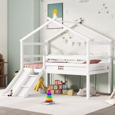 a child's bedroom with a white bunk bed and slide