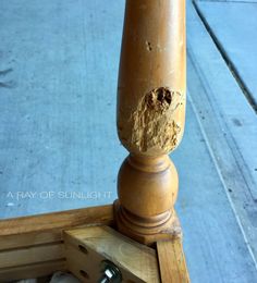 a close up of a wooden post on the sidewalk