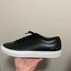 Brand New Common Projects, Never Worn Before Black Sneakers With Textured Sole And Medium Fit, Classic Black Sneakers With Contrast Sole, Classic Black Sneakers With Contrasting Heel Counter, Classic Black Sneakers With Textured Sole, Black Low-top Custom Sneakers, Classic Black Sneakers With Leather Sole, Classic Black Custom Sneakers With Contrast Sole, Custom Black Leather Sneakers With Contrasting Heel, Classic Black Formal Sneakers