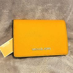 Michael Kors Jet Set Medium Slim Leather Wallet In A Lovely Yellow Color (Sun). Snap Closure, Tons On Room For 5-6 Cards, A Coin Purse, Clear Id Slot, And A Few Extra Hidden Areas Brand New With Tags Sun Snap, Slim Leather Wallet, Kors Jet Set, Michael Kors Jet Set, Jet Set, Michael Kors Bag, Yellow Color, Snap Closure, Leather Wallet