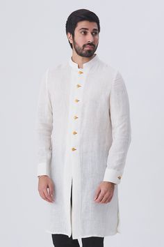 White linen kurta with front and cuff button placket
Components:1
Neckline:Mandarin
Sleeve Length:Full
Fabric:Linen
Color:White
Note: Pants worn by the model is not for sale - Aza Fashions Traditional Long Sleeve Kurta With Button Closure, Traditional Cotton Kurta With Button Cuffs, White Long Sleeve Kurta With Buttons, Casual White Linen Kurta, White Long Sleeve Bandhgala For Spring, White Fitted Kurta With Stand Collar, Traditional Long Sleeve Linen Kurta, Long Sleeve Off White Kurta For Summer, White Linen Fitted Kurta