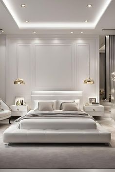 a large white bed sitting in a bedroom next to a wall mounted light above it