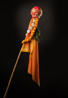 an orange and yellow flag with a red headdress hanging from it's side