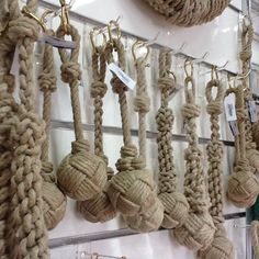 there are many rope balls hanging on the wall