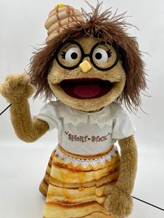 a stuffed animal wearing glasses and a skirt