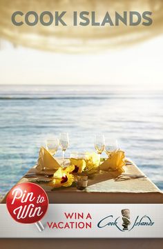 a table with wine glasses and food on it in front of the ocean that says cook islands