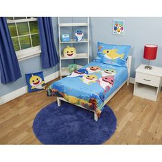 a child's bedroom with blue walls and wooden flooring, including a bed