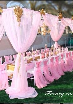 there are many pink chairs and tables set up