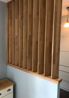 an empty room with wood paneling on the wall and drawers in front of it