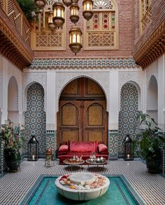 a living room filled with lots of furniture and decor on top of a blue tiled floor